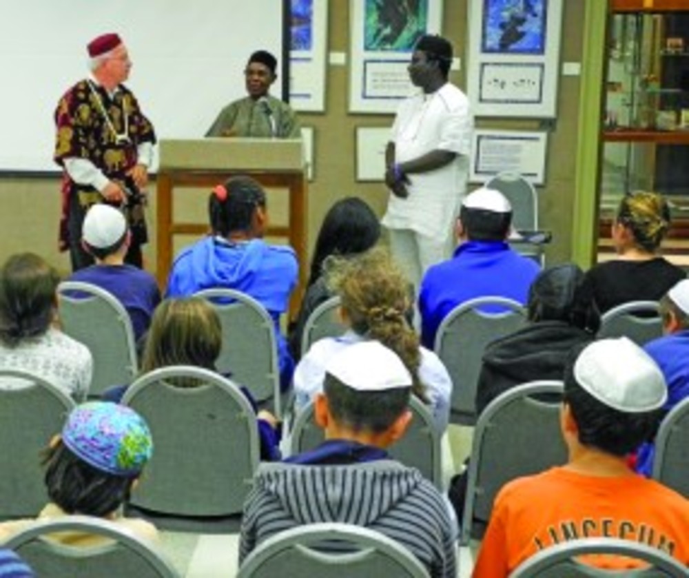 From left, Temple Emanu-El Rabbi Wayne Franklin, Ovadiah Agbai and Pinchas Ogbukaa address a group of students. /Shai Afsai